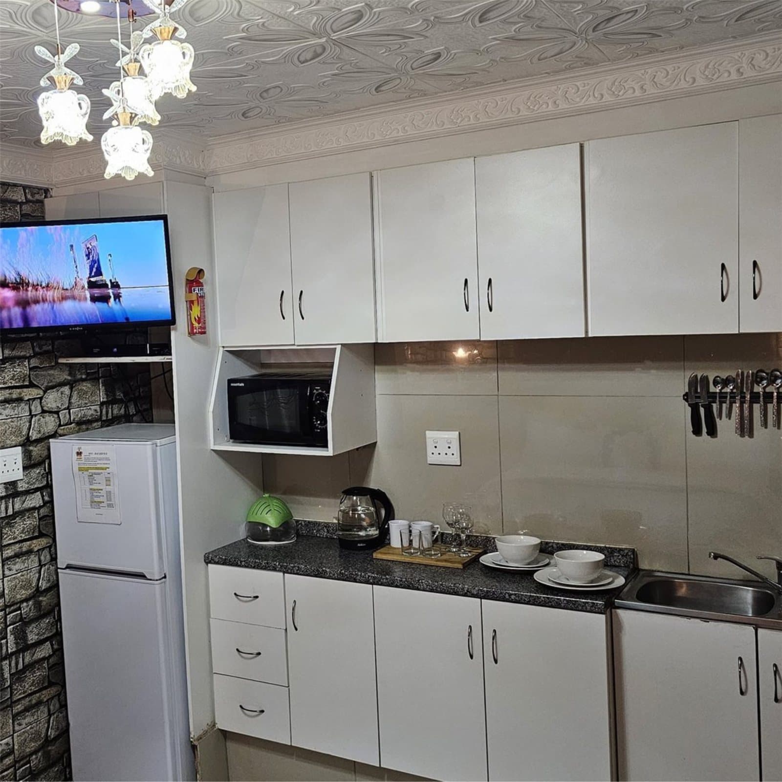 Fully equipped kitchenette with fridge, microwave, kettle and flat-screen TV
