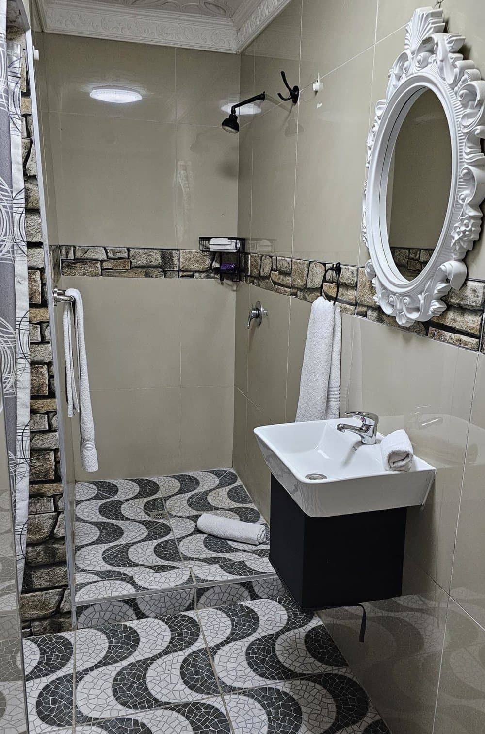 En-suite bathroom with walk-in shower, stone accents and fresh towels